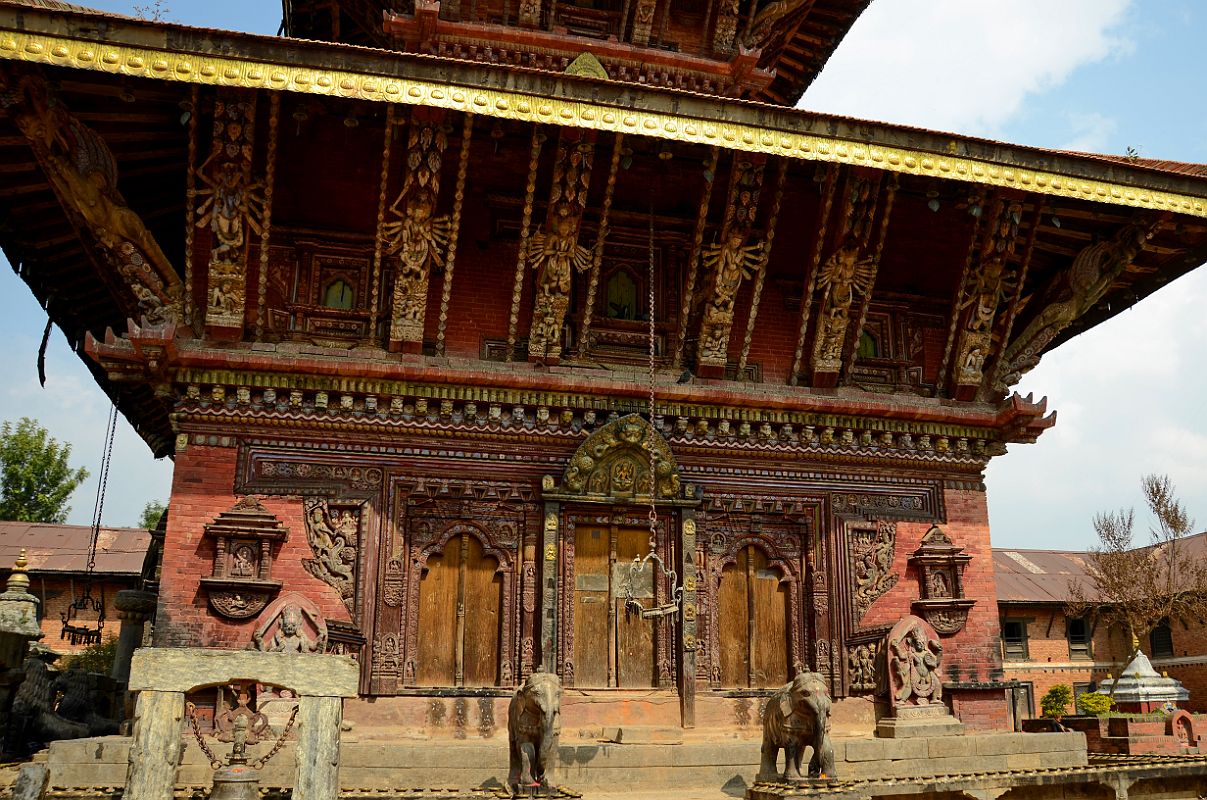 Kathmandu Changu Narayan 06 South Entrance To Changu Narayan Temple The roof struts of the Changu Narayan Temple south side feature multi-armed Tantric deities while below a pair of elephants guard the entrance. The temple main entrance is on the left.